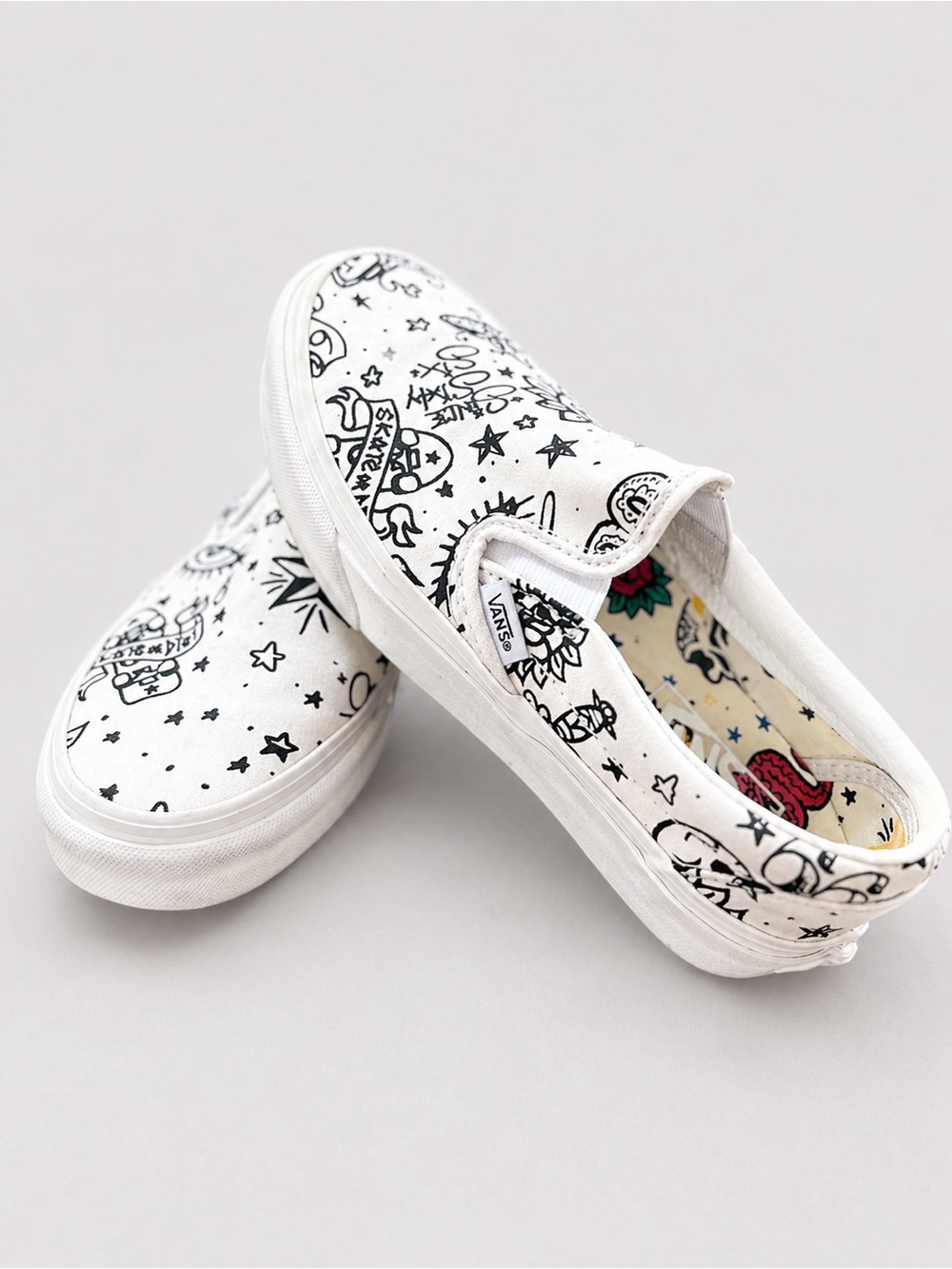 Vans White Slip-On Sneakers with Black Graphic Print